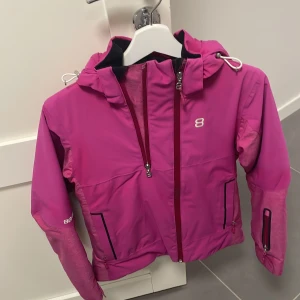 Rosa jacka från 8848 Altitude - Säljer en snygg rosa jacka från 8848 Altitude. Jackan har en dragkedja framtill och en praktisk huva. Perfekt för kyligare dagar med sin stilrena design och funktionella detaljer.