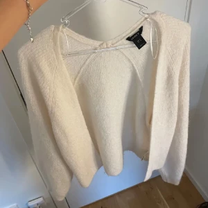 Beige kofta från Lindex - Mysig beige kofta från Lindex i en mjuk och fluffig textur. Perfekt för kyligare dagar med sin långärmade design. Enkel att matcha med olika outfits för en avslappnad look.
