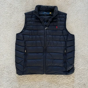 Polo Ralph lauren väst - Säljer denna nästintill oanvända raffe västen i en marinblå färg💯|| Skick 10/10 || Nypris= Runt 3000 kr || Vårt pris= 1600💯🤩|| Pris kan såklart diskuteras✌️