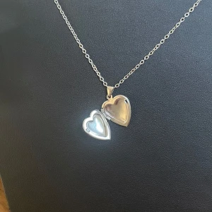 Halsband - Medaljong  - Egengjort silverfärgat halsband i rostfritt stål med hjärtmedaljong som går att öppna. 🩶Kolla gärna resten av mina annonser för samfrakt.