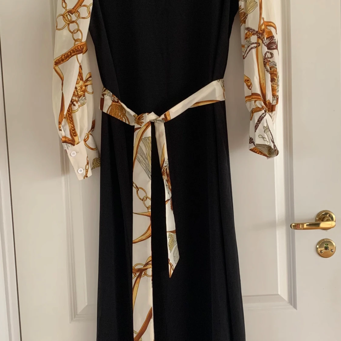 Svart klänning med mönstrade ärmar - 90