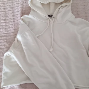 Vit hoodie - Vit hoodie från bikbok. Lite cropped modell i ett mjukt tyg. 