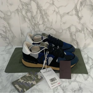 Valentino rockrunner sneakers  - Snygga Valentino Garavani sneakers i blått och svart med ett unikt mönster. Dessutom helt oanvända. Skorna har snörning och en robust sula för extra grepp. Perfekta för en stilren look 