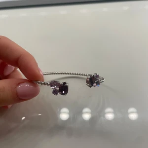 Caroline svedbom armband  -  silverarmband med lila stenar. Knappt använt men saknar asken. Armbandet är justerbart och passar de flesta handleder. Nypris:795kr 