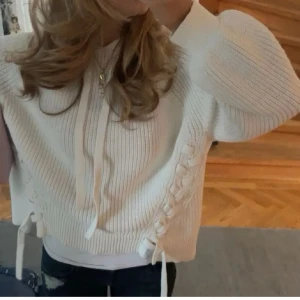 Vit stickad hoodie med snörning - Säljer en snygg vit stickad hoodie med snörning på sidorna. Bilderna är lånade men skriv privat för fler bilder 