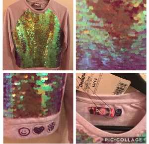 Ny Desigual tjocktröja med paljetter bling st 158/264 (xs-s) - Ny med lapp. Desigual i ljuslila college tröja med hela framsidan full av vändbara paljetter i pastell skimrandefärger. Den ser väldig grön ut men det stämmer inte. Den skimrar i rosa, lila, blå,grön. Supé gin college tröja.  Finns fler bilderNypris 699:-