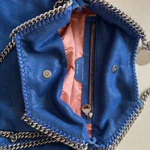 STELLA MCCARTNEY VÄSKA - Hej ✨ Säljer min finfina blåa Stella McCartney väska. 💙 Den inköptes från hemsidan och den har använts sparsamt. Några missfärgningar inuti väskan pga läppstift. Säljs i befintligt skick 🥰  
