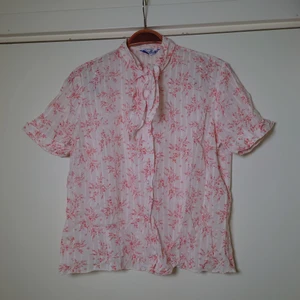 Vintageblus - Tunn vintageblus i vitt med ljust rött mönster och knytning vid halsen. Ingen storleksmärkning men är som en M🌿