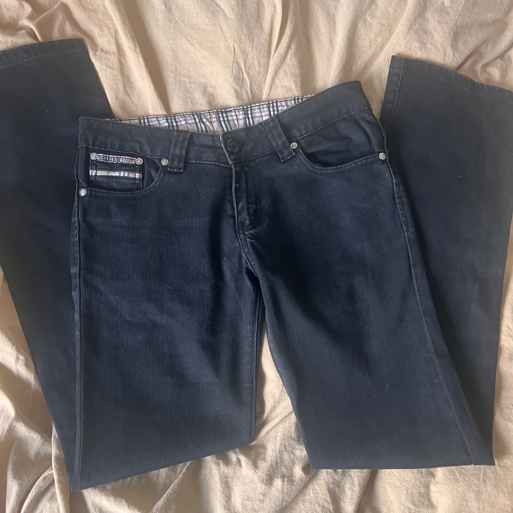 Jättesnygga, svarta, lågmidjade Burberry jeans med detaljer på bakfickan. Jeansen är raka i modellen och är i mycket bra skick. Midjemått rakt över: 39,5 cm. Innerbenslängd: 80 cm. Ben öppning: 20 cm. Jeans & Byxor.