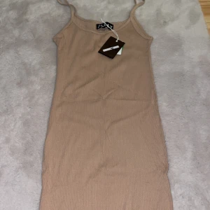 Klänning  - Säljer en beige klänning med prislappen kvar!