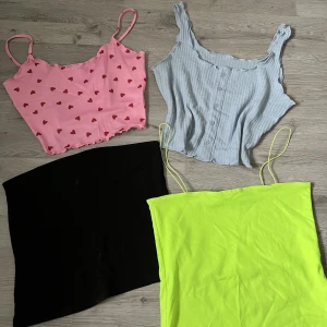 Klädpaket linne  - Säljer då de inte kommer till användning. Paketet består av en bandeau topp (L) neongult linne (M) blått linne (L) och linne med hjärtan (M) Alla för 100kr! 