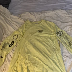 Tröja - Säljer nu en knappt använd tunn tröja i en stark neon färg! Det står ”Women” på armarna i olika texttyper. Tröjan är köpt från monki och den är ganska oversized! Storlek S😊