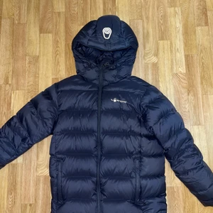 Sail racing jacka - Cloud down hood heter modellen. Köpt på kids brand store förra året för 2500kr. Den är endast använd en säsong men är lite sliten på märket. Annars i fint skick!