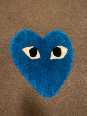 Cdg hart matta  - Egengjord cdg hart matta i blå  Storlek ich 50x50 Den är gjord med en tufting pistol som skjuter ut garn. Med 100% akryl garn.  