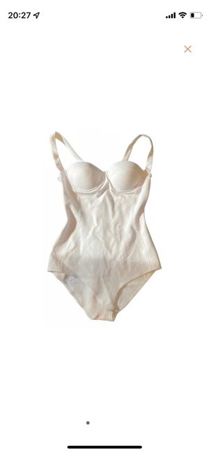White bodysuit - White body. Never worn. Cotton, stretchy material. Opaque. Built-in bra.  Measurements flat: Bust: 41 cm Waist: 33 cm Hips: 44 cm Torso length from base to top of cups: 56 cm