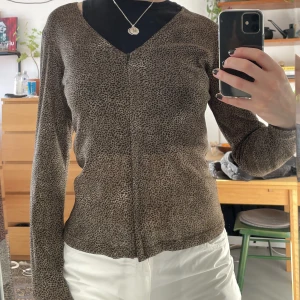 Topp leopard med dragkedja - Långärmad topp i leopard. Den har också dragkedja som gör att man kan ha den helt öppen. Bra skick förutom en söm som gått upp vid vänstra axeln (se bild 3), därav det billiga priset. 