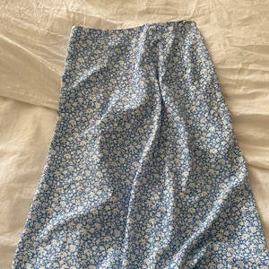 Blommig kjol - Lång blå kjol men slits,fin till sommaren.