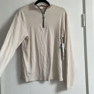 Ribbad beige tröja - Ribbad beige tröja med dragkedja, aldrig använd. Storlek XL men tight modell. Frakt tillkommer