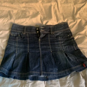 jeans kjol - söt mörkblå jeanskjol som är i storlek 40. den är använd men i nyskick. inga defekter. midjemåttet är 47 cm tvärs över. 