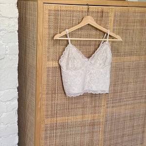 Beige crop top i spets - Vad: En så fin beige crop top. Stretch i ryggen och banden kort att justera. Märke: Bikbok Storlek: S  Material: 90 polyamid 10 elastan  Skick: Små tråddragningar här och var, men inget som man tänker på.