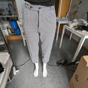 Pants with a black and white checked pattern