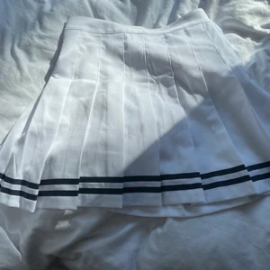 Striped vit kjol - Vit kjol i storlek 34-36 med 2 svarta stripes längst ner. Jag beställde denna för inte så länge sedan på shein men insåg att den vart lite för stor för mig (154cm), så den har används ungefär totalt endast en gång. Jag rekommenderar verkligen kjolen!