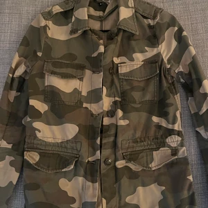 En camoflage jacka - En camoflage jacka från hm i storlek 34. Har jättefina cargo-liknande detaljer på axlar och fickor. Det är i ett superfint skick! Du står för frakt
