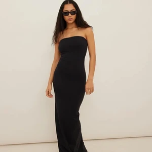 Svart bandeau klänning - Svart maxiklänning i bandeaumodell från Freja Wewer x NA KD. Super snygg men fick fel storlek. Aldrig använd och med alla lappar kvar. 