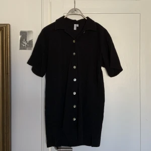 Black shirt dress  - This dress has a loose fit and stops above the knee, sea shell buttons and barely used :) 