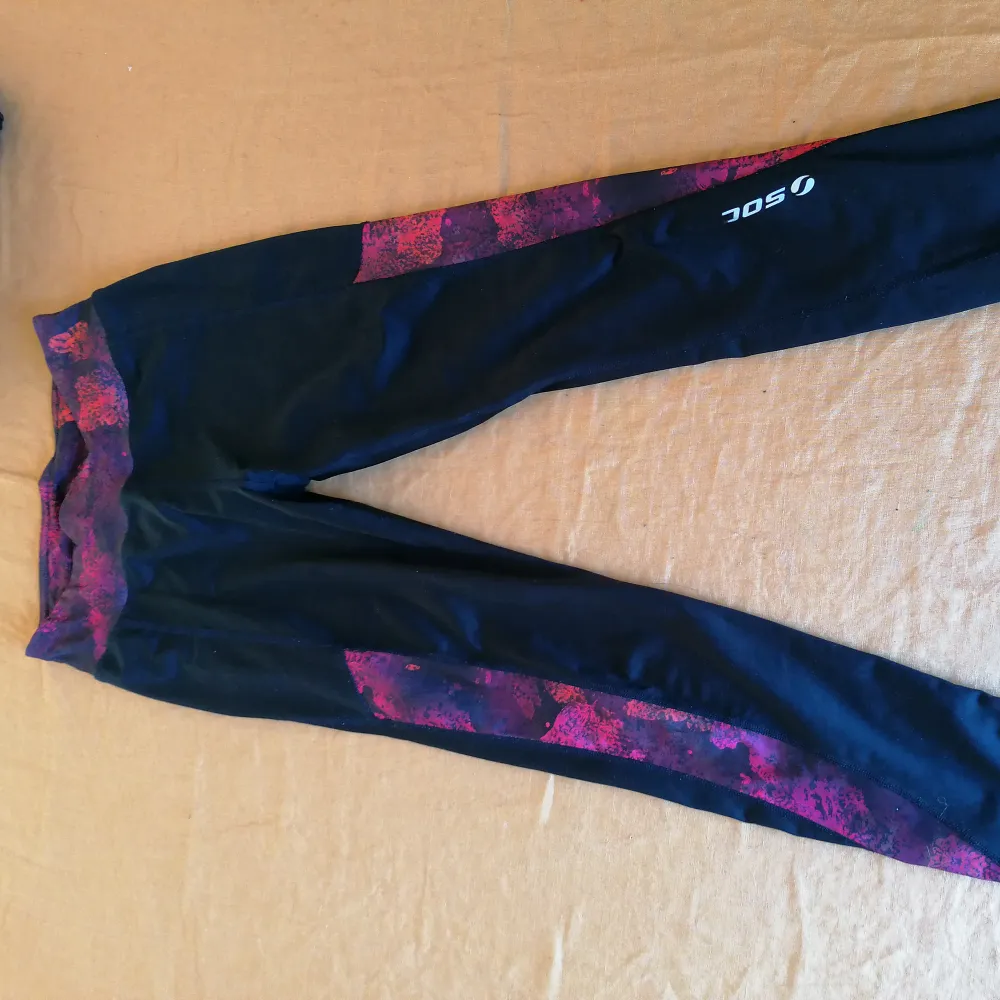 Svarta träningstights från Soc (stadium) med rosa/lila detaljer.. Jeans & Byxor.