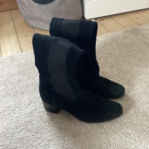 Boots - Ett par svarta stövlar som går under knät på mig som är 177 lång. Varan har tecken på användning men är i bra skick. 