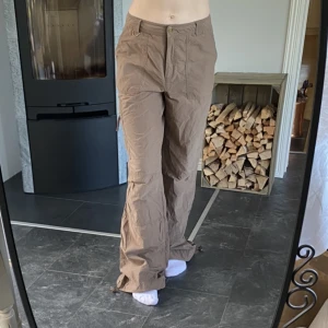 Bruna cargopants  - Bruna cargopants från Kappahl, väldigt bra secondhand skick utan några defekter 💕 Midjemått 39 cm rakt över, innerbenslängd 82 cm 💗 Dragsko längst ner, färgen är lite mörkare irl 