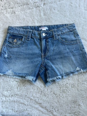 Blå jeansshorts med fransig kant