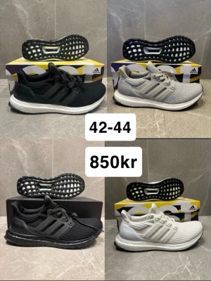 Adidas Ultraboost sneakers - Snygga Adidas Ultraboost sneakers i flera färger: helsvart, svart med vit sula, ljusgrå och helvit. Skorna har stickad ovandel, Boost-mellansula och klassiska tre ränder på sidan. Perfekta för dig som gillar sportig och modern stil.