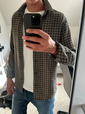 Brunrutig overshirt med krage - Säljer nu en riktigt schysst skjorta som även funkar som overshirt. Schysst skjorta som passar året runt även nu på sommaren. Det finns inga skador och skjortan är i riktigt bra skick utan några skador. Jag på bilden är 188cm. Hör av er vid fler frågor och eventuella prisförslag:)