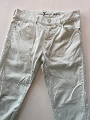 Ljusturkose jeans 29/32 (for all mankind ronnie) - Snygga ljusgrå jeans i slim fit-modell med klassisk femficksdesign och knappgylf. Jeansen har raka ben och är tillverkade i ett mjukt, stretchigt material som ger en bekväm passform. Perfekta för dig som gillar en stilren och enkel look. W29/32