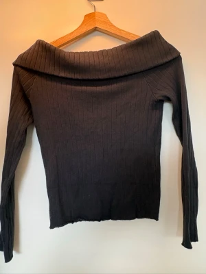 Svart off shoulder stickad tröja H&M - Säljer en svart ribbstickad tröja från H&M med off shoulder-krage. I storleken 146/152.