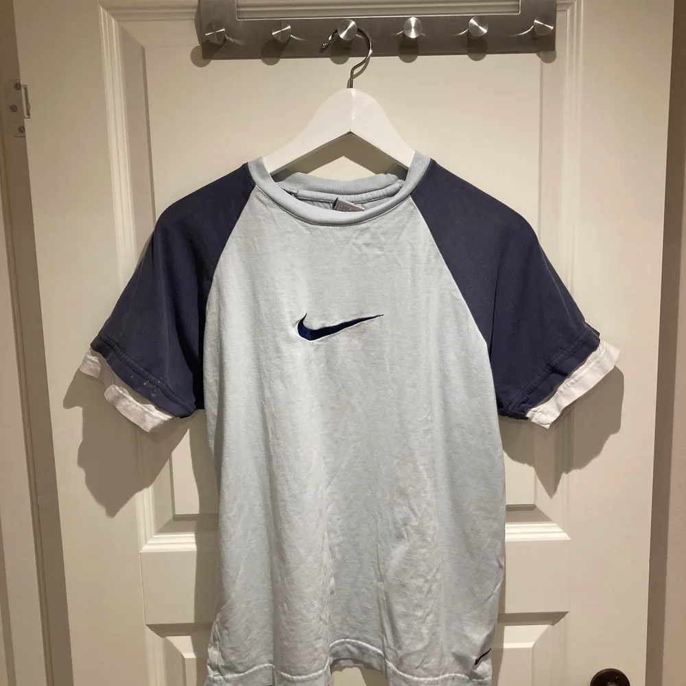 Fin blå Nike T-shirt! Tror det är barnstorlek L men osäker.. sitter hursomhelst som typ S/M! I fint använt skick, har en fläck på ärmen som bilden visar. Tröjan är ljusblå o mörkblå!. T-shirts.