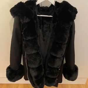 Svart parka jacka fuskpäls - Säljer denna fina parkajacka med fuskpäls. Köpt från Butik Garoff för 1699kr (ord.pris 2499kr) säljer för 1200kr. Den är i princip som ny då den är köpt för någon månad sedan och använd max 5 gånger. Hör av dig om du är intresserad :)
