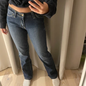Lågmidjade Lee jeans - Lågmidjade Lee jeans i en utsvängd modell, sitter perfekt på mig som är 160 och vanligtvis har w27/28! Frakt tillkommer, köp direkt för 250kr!