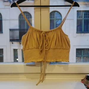 Smocked summer top - Strappy croptop with smocks and spaghetti tie in front. Soft textured jersey in cappucino color. I can send photo while wearing if you ask. 