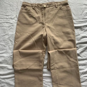 Straight leg pants - Straight leg and low-waisted beige pants. Fits sizes XS-S. 