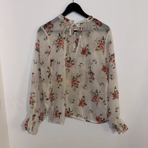 Blommig blus - Säljer denna blommiga blus från lager 157. Den är lite genomskinlig och har muddar vid handlederna. Går att knyta om man vill vid halsen. Pris 40kr + frakt 🌸