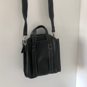 Svart Handväska  - En svart väska köpt i Milano för flera år sedan. Osäker på märket. I väldigt fint skick bara använda  1-2 gånger. 