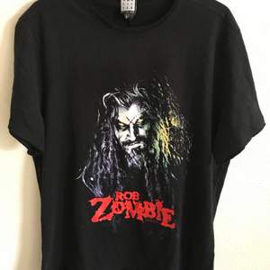 Rob Zombie Metal Band Horror T-Shirt  Size large, fits like a regular men’s medium. Great condition, no flaws or damage. Brand new, unworn. DM if you need exact size measurements.   Buyer pays for all shipping costs. All items sent with tracking number.   No swaps, no trades, no offers. 