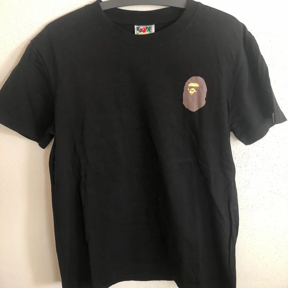 Bape / A Bathing Ape Multi Logo T-Shirt  Size medium, fits like a regular men’s small. Great condition, no flaws or damage.  DM if you need exact size measurements.   Buyer pays for all shipping costs. All items sent with tracking number.   No swaps, no trades, no offers. . T-shirts.