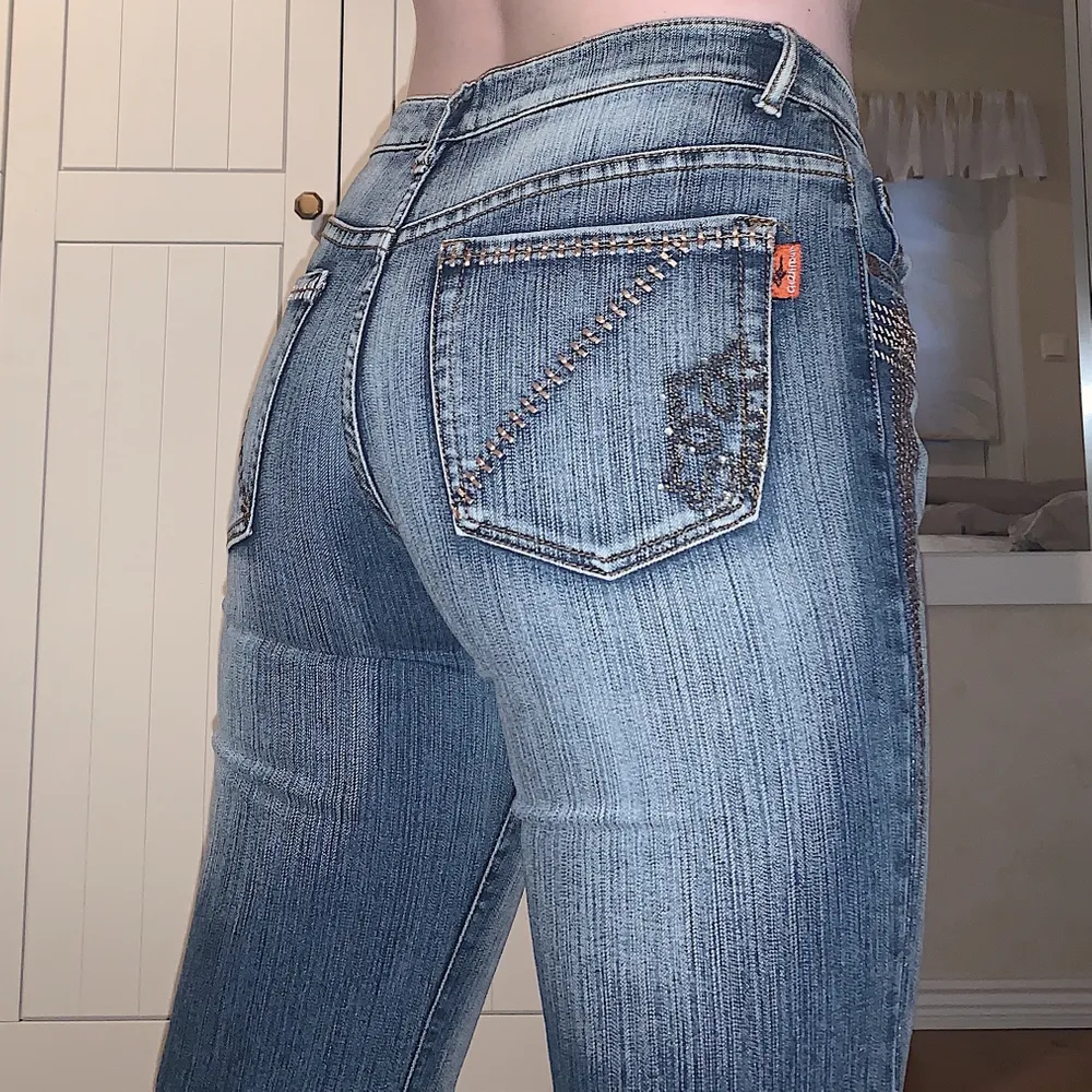 Säljer dessa coola flared, lowrise, jeans med coola detaljer på fram och bak (OBS: några rhinestones har trillat av)! Storleken är large men skulle säga att de passar XS-M (väldigt stretchiga)!✨ Jag själv brukar har W28/29 och är 172cm💗 Budgivning i kommentera om det är många intresserade❤️. Jeans & Byxor.