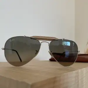 Klassiska Pilot solglasögon från ray ban som aldrig går ut ur mode. Supersnygga med en beige skin bit detalj och brunt glas. Använda, bra skick. Äkta såklart, inget kvitto kvar. Köpte i en butik i Nice, Frankrike. Priset kan diskuteras. Ord pris 1700kr