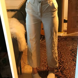 Beigea tyg byxor med detaljerad knapp - Super fina beigea tygbyxor från monki. Sitter super fin och gillar väldigt mycket men tyvärr har dom blivit för korta. Dom är kanske 1 år gammla men har inte använt så många gånger så nästan nyskick. Jag är 1,67 cm lång och dom är lite korta men funkar om man vill visa början av benet!! Dom har en detaljerad knapp på och det finns en extra på en lapp i byxan!Nypris var 350 frakt tillkommer 66kr