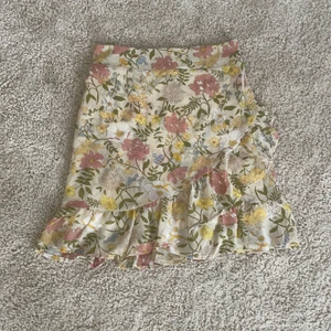 Blommog kjol  - Säljer denna superfina kjolen då jag köppte fel storlek. Kjolen är ganska liten i storleken. Den har volang, och resår i midjan. Kjolen är endast testad så i väldigt bra skick. Nypris är 350 kr. Frakt tillkommer 😊